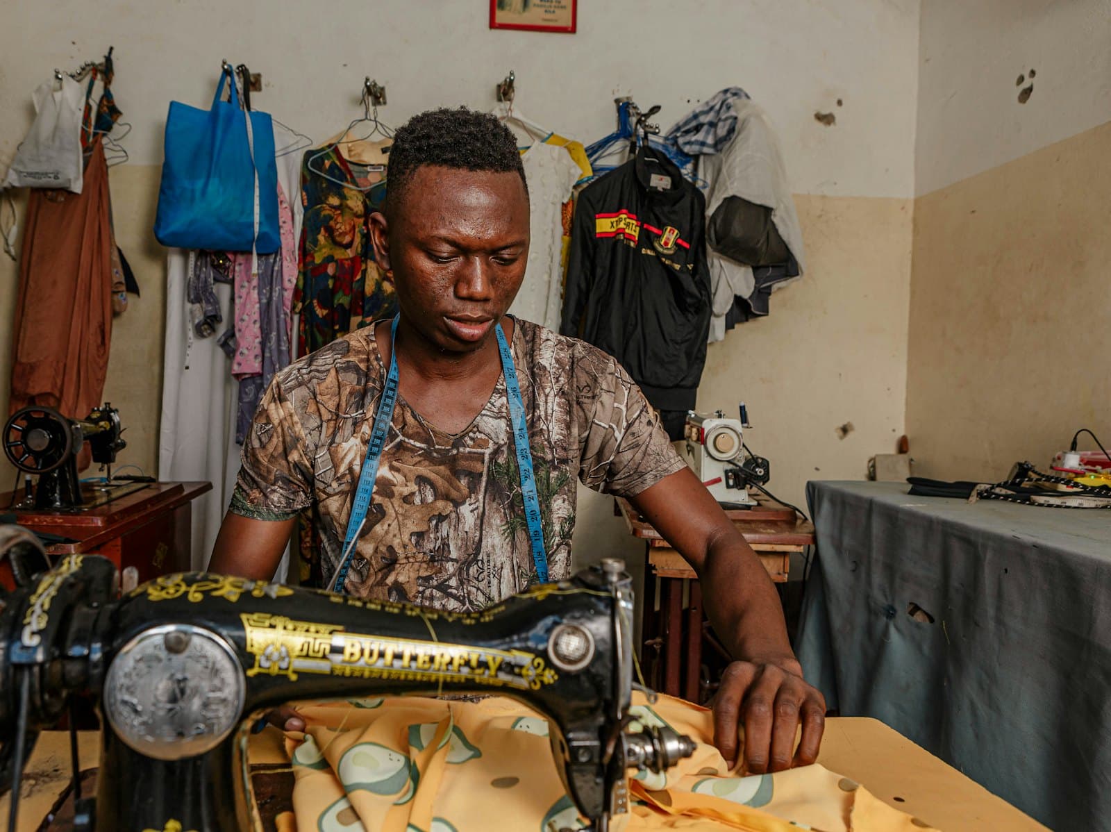Tailor sewing in his workshop